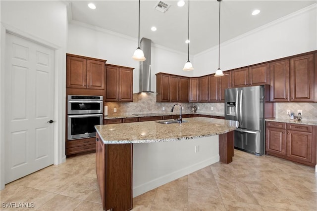 kitchen with a center island with sink, visible vents, light stone countertops, stainless steel appliances, and a sink