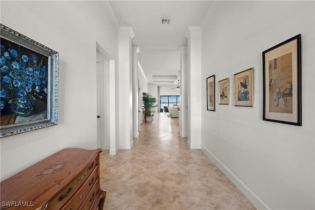 corridor with visible vents, crown molding, and baseboards