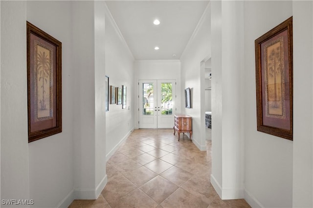 interior space featuring french doors, light tile patterned flooring, crown molding, and baseboards