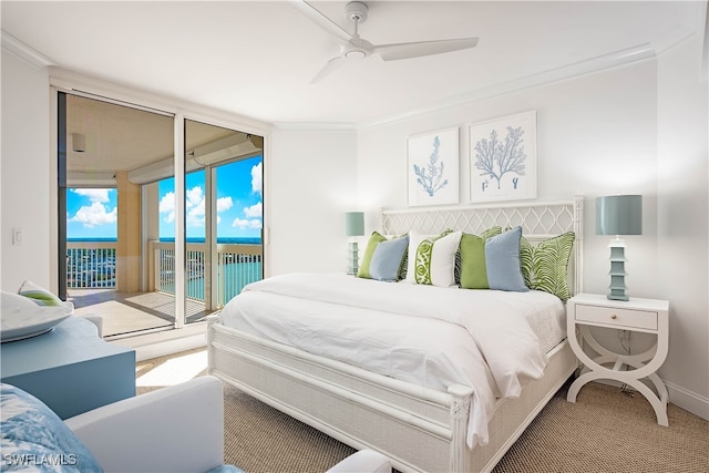 bedroom featuring a water view, ornamental molding, carpet flooring, a wall of windows, and access to exterior