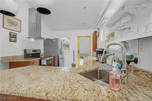 kitchen featuring kitchen peninsula, sink, stainless steel appliances, and wall chimney range hood