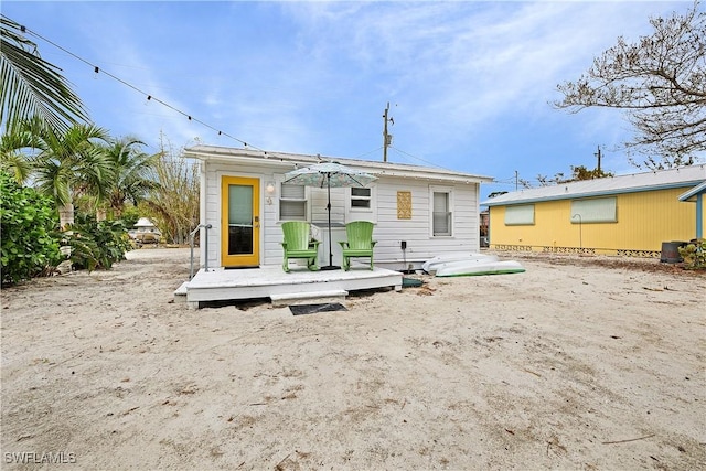 back of property featuring a wooden deck