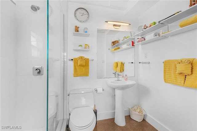 bathroom with a shower with shower door and toilet