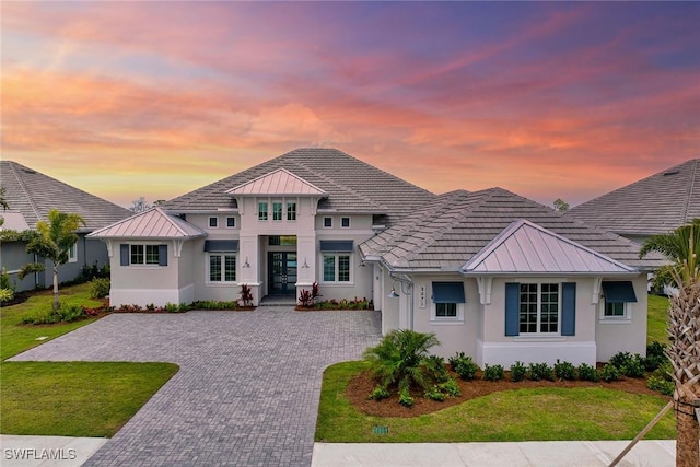 8871 Nevis Way, Naples, FL 34112 - view of front of home with stucco siding, french doors, and a standing seam roof