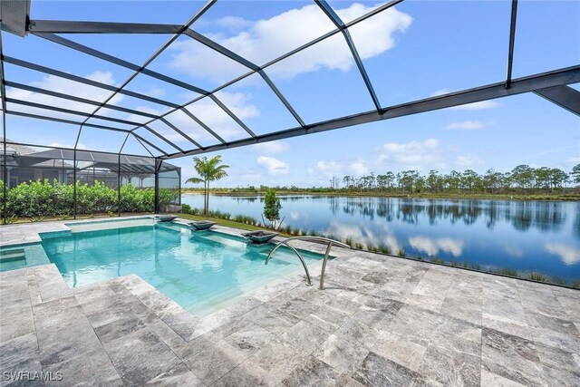 view of pool featuring a patio area, a water view, and glass enclosure