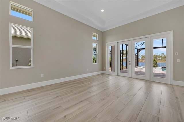 empty room featuring french doors and light hardwood / wood-style floors