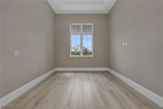 8871 Nevis Way, Naples, FL 34112 - spare room with light wood-style floors, baseboards, and a tray ceiling