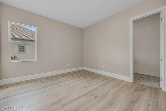 8871 Nevis Way, Naples, FL 34112 - unfurnished bedroom featuring baseboards and light wood-type flooring