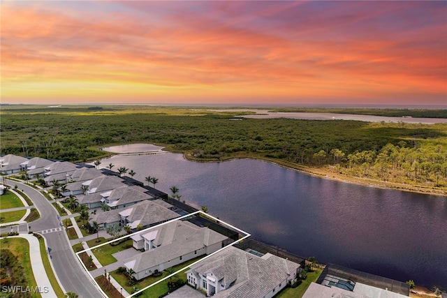 aerial view at dusk with a water view