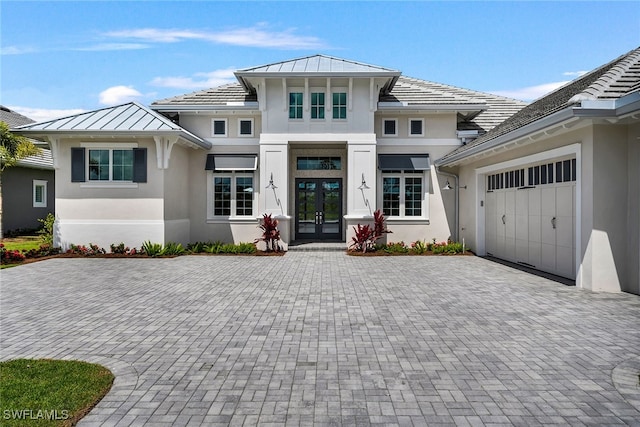 view of front of property with french doors and a garage