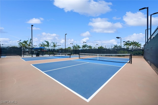 view of tennis court with basketball hoop