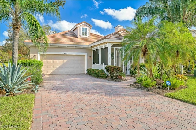 view of front of house featuring a garage and a sunroom