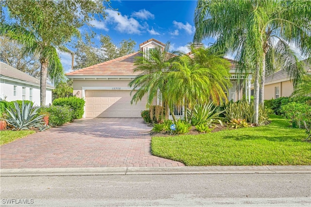 view of front of home with a front yard and a garage