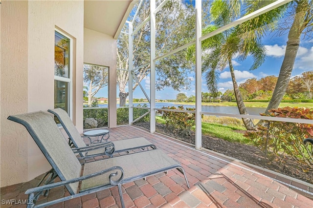 sunroom / solarium with a water view