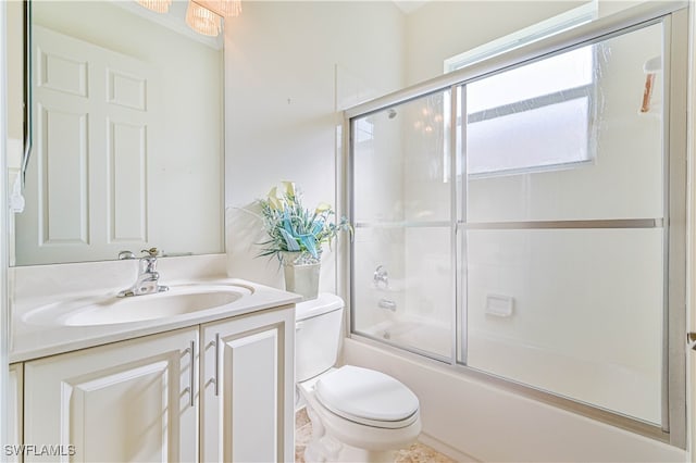 full bathroom with toilet, combined bath / shower with glass door, and vanity