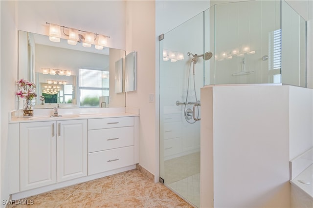 bathroom with vanity, a shower with shower door, and tile patterned flooring