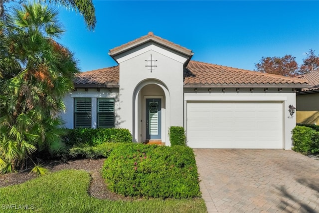 mediterranean / spanish-style home with a garage