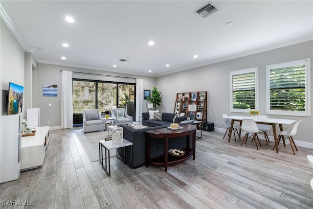 living room with crown molding and light wood-type flooring