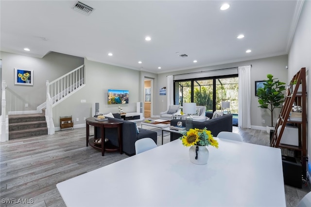 dining area featuring ornamental molding and light wood-type flooring