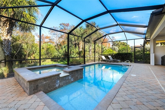 view of pool featuring an in ground hot tub, a patio, and glass enclosure