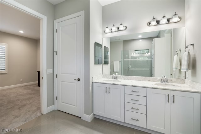 bathroom with vanity, a shower with shower door, and tile patterned flooring