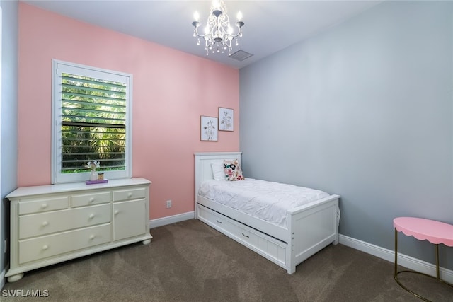 bedroom with dark carpet and a notable chandelier