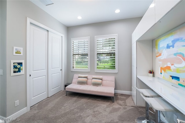 sitting room featuring light colored carpet