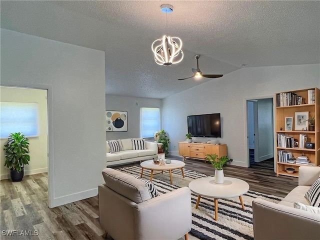 living room featuring hardwood / wood-style floors, a textured ceiling, vaulted ceiling, and ceiling fan