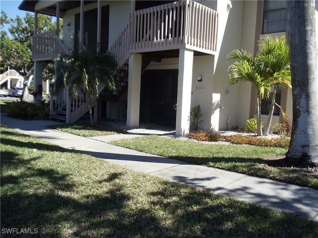 exterior space featuring stairway and stucco siding