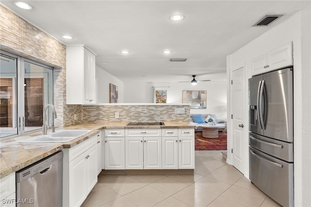 kitchen with white cabinetry, sink, ceiling fan, tasteful backsplash, and appliances with stainless steel finishes