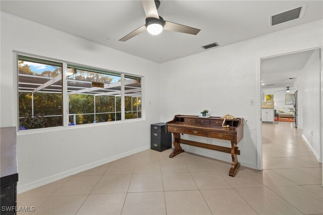 interior space featuring light tile patterned floors and ceiling fan