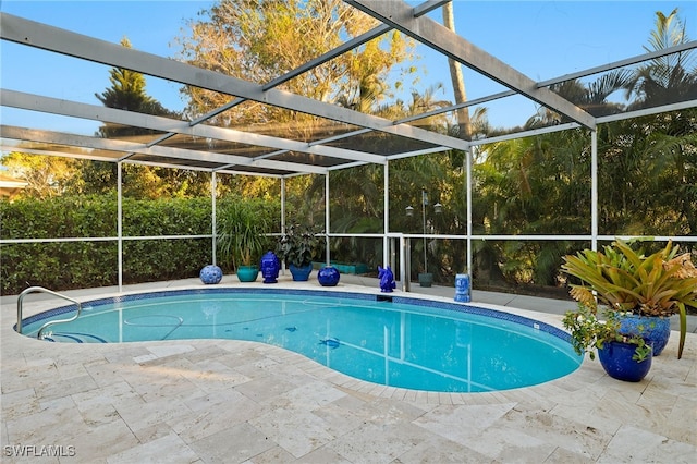 view of pool featuring a patio and glass enclosure