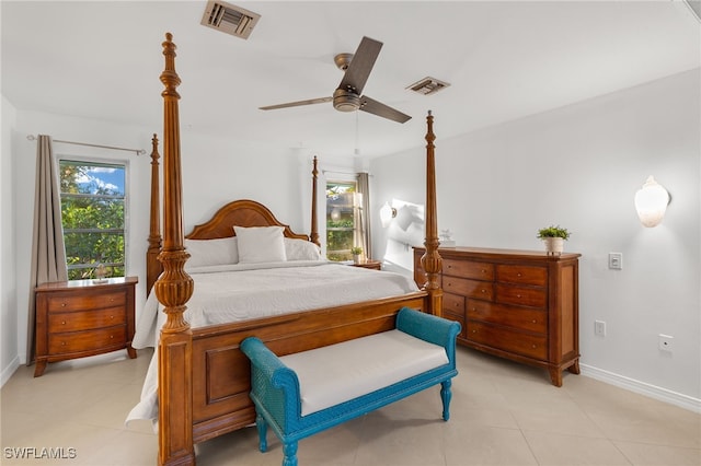 bedroom with multiple windows, light tile patterned floors, and ceiling fan