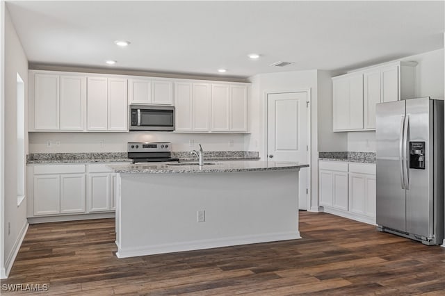 kitchen with dark hardwood / wood-style flooring, appliances with stainless steel finishes, white cabinets, and an island with sink