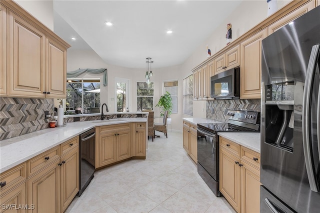 kitchen with backsplash, pendant lighting, sink, and black appliances