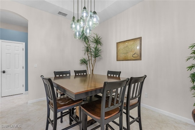 dining room with light tile patterned flooring and an inviting chandelier