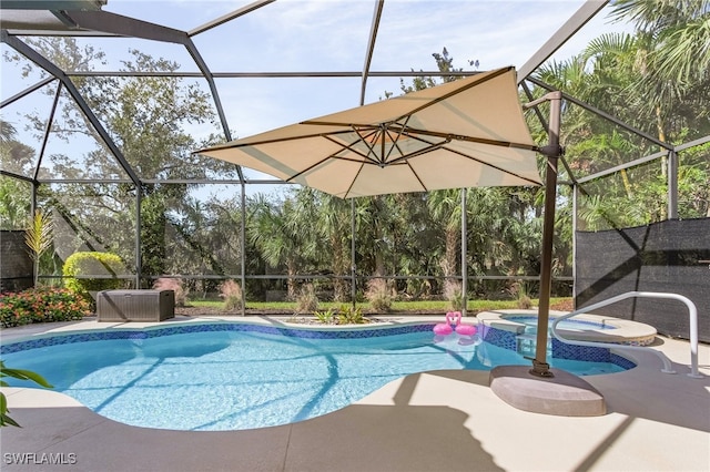 view of pool with a patio, glass enclosure, and an in ground hot tub