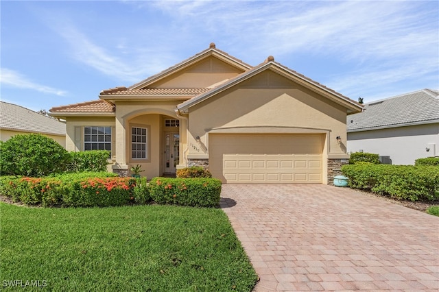 view of front of house with a front yard and a garage