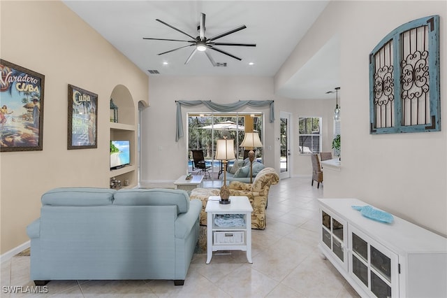 living room featuring ceiling fan and light tile patterned flooring