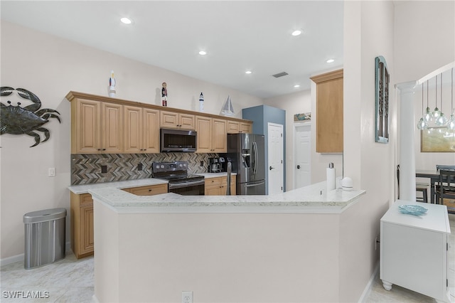 kitchen with light stone counters, kitchen peninsula, decorative columns, backsplash, and appliances with stainless steel finishes