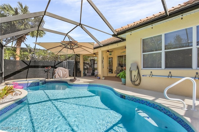 view of pool with a patio and glass enclosure