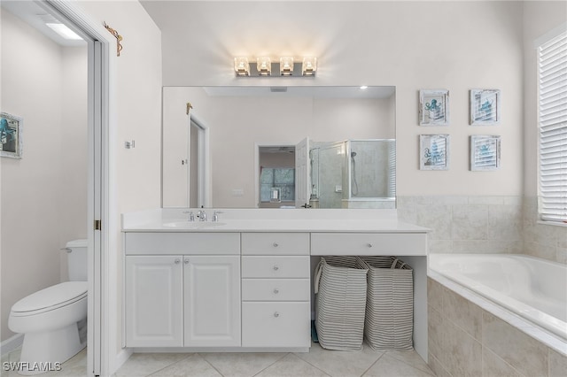 full bathroom featuring tile patterned floors, vanity, toilet, and shower with separate bathtub