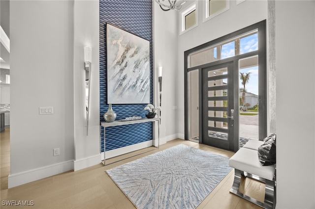 foyer featuring a high ceiling and light hardwood / wood-style floors