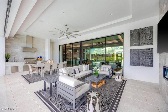 living room featuring ceiling fan, tile walls, and light tile patterned floors