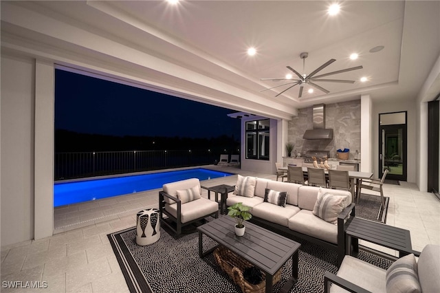 interior space with an outdoor hangout area, a grill, a fenced in pool, and ceiling fan