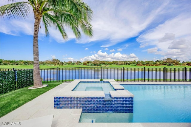 view of swimming pool with an in ground hot tub, a lawn, and a water view