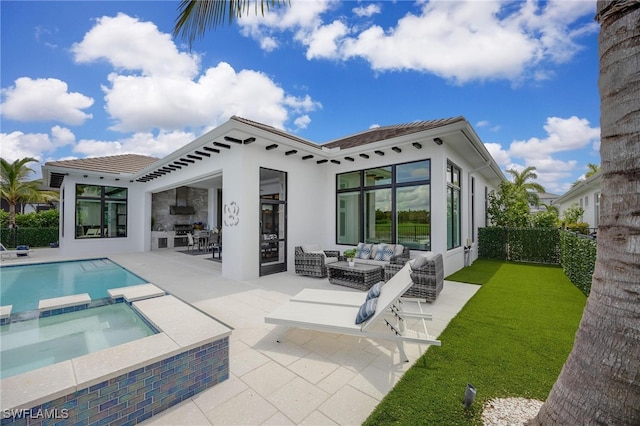 rear view of property featuring a yard, an outdoor living space, a pool with hot tub, and a patio area