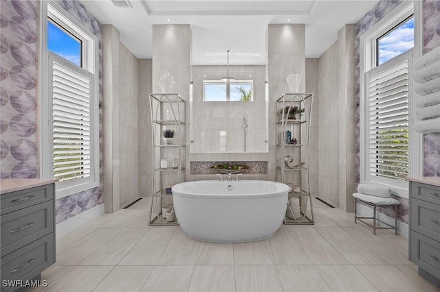 bathroom featuring vanity, tile walls, and a wealth of natural light