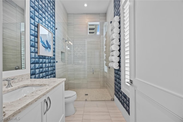 bathroom with toilet, an enclosed shower, vanity, and tile patterned floors