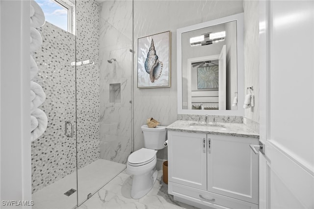 bathroom with vanity, toilet, and an enclosed shower